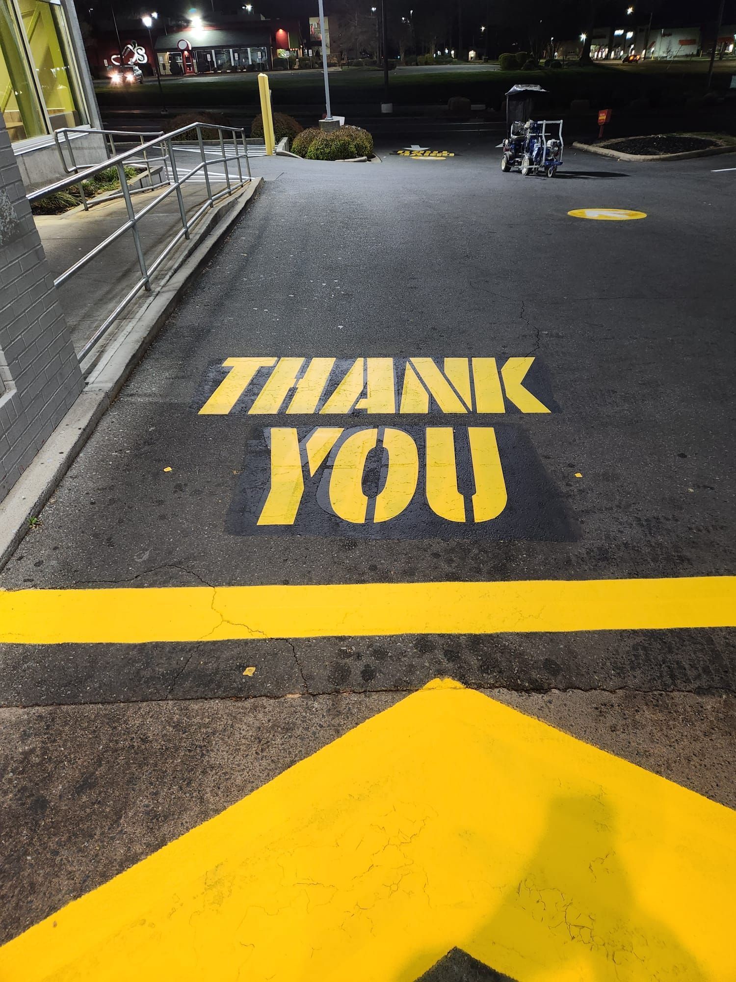 A parking lot with a stencil that says thank you