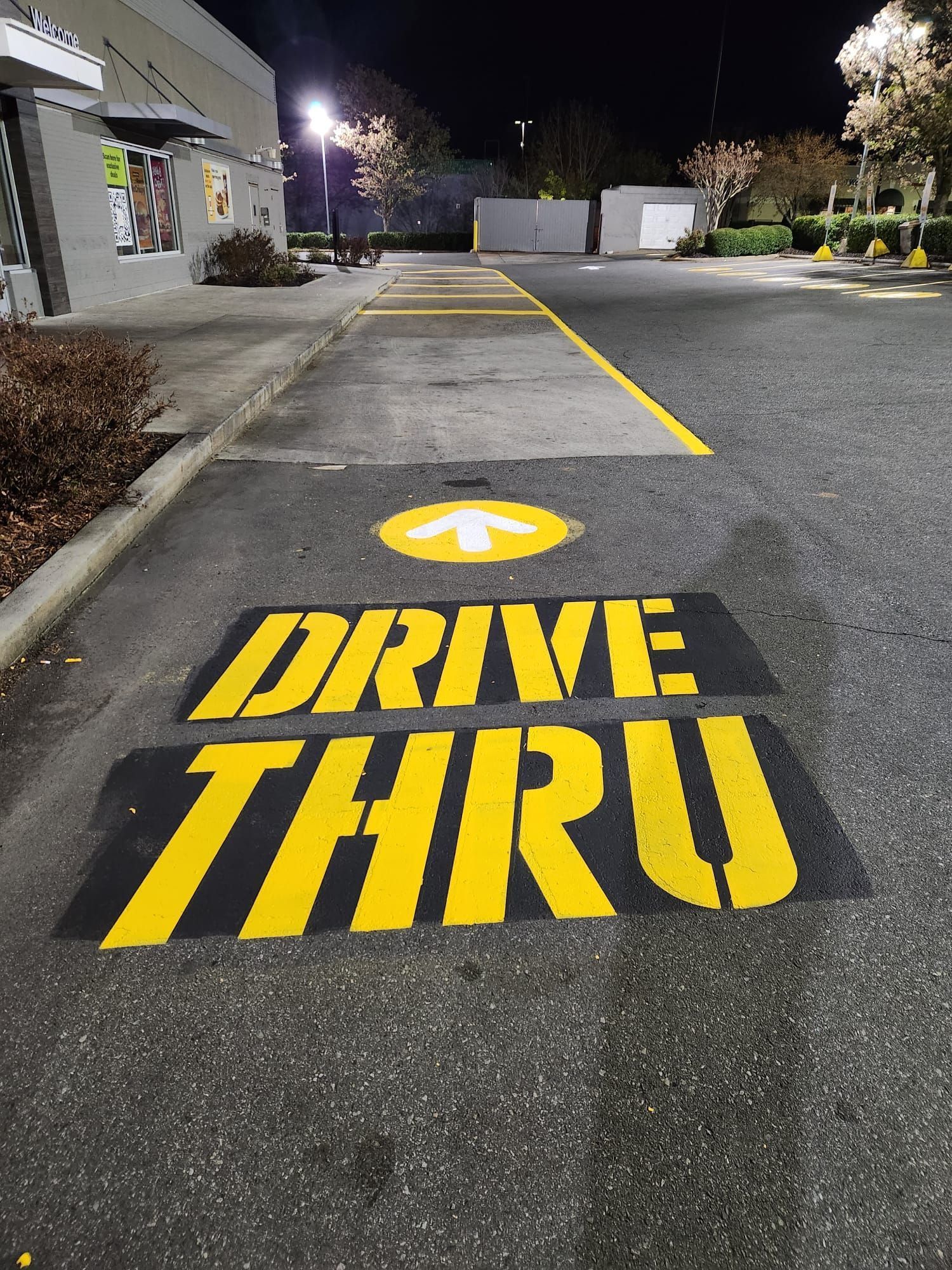 A drive thru sign is painted on the side of the road