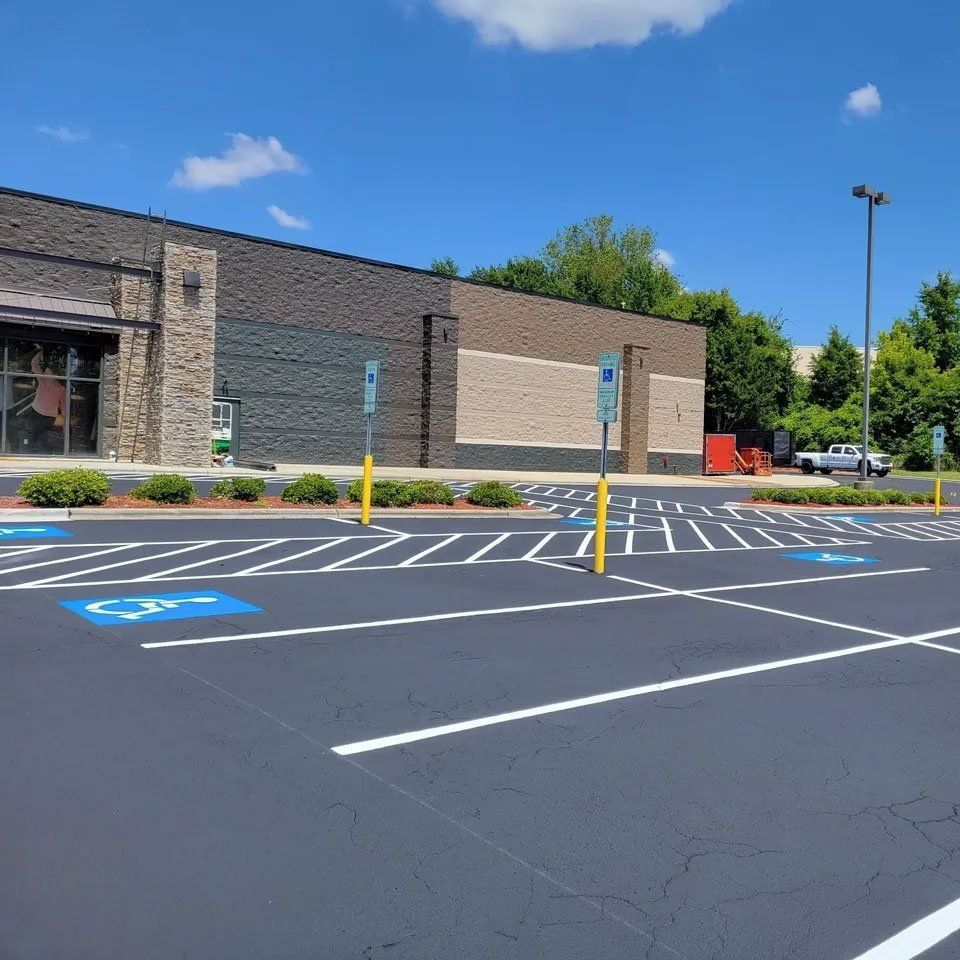 A parking lot with a handicap sign in the middle