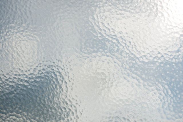 A close up of a glass texture with a swirl pattern.