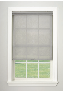 Gray roller shade on a window with a white frame, covering a view of a grassy yard.