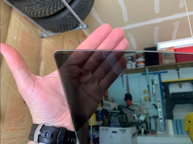 A person holding a piece of glass in their hand