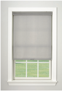Gray roller shade on a window, with green grass visible through the window.