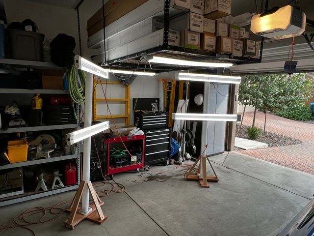 A garage with a bunch of lights hanging from the ceiling