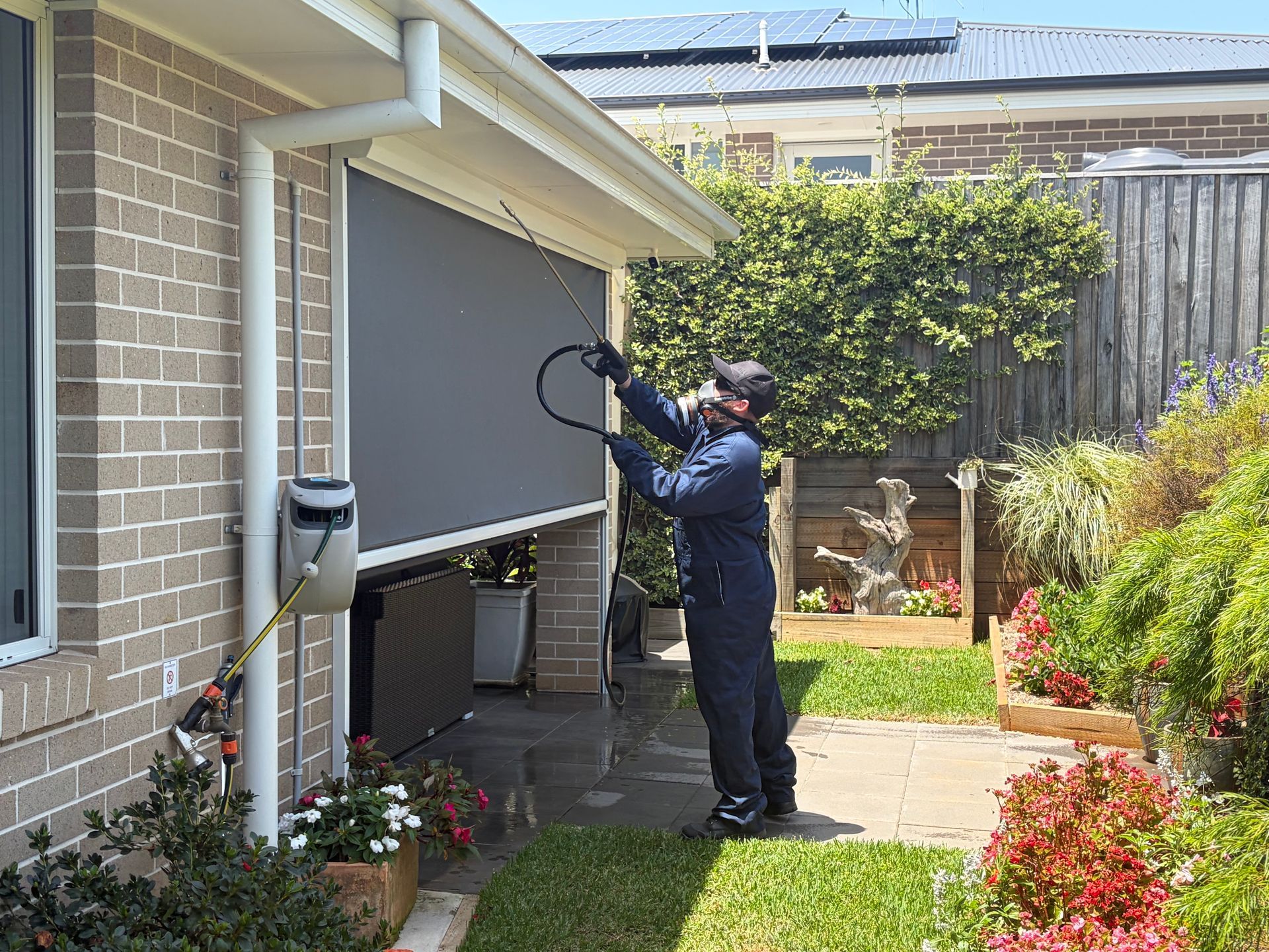 A Person in Blue Jumpsuit Operates an Outdoor Shade — FUMATEX In Port Macquarie, NSW