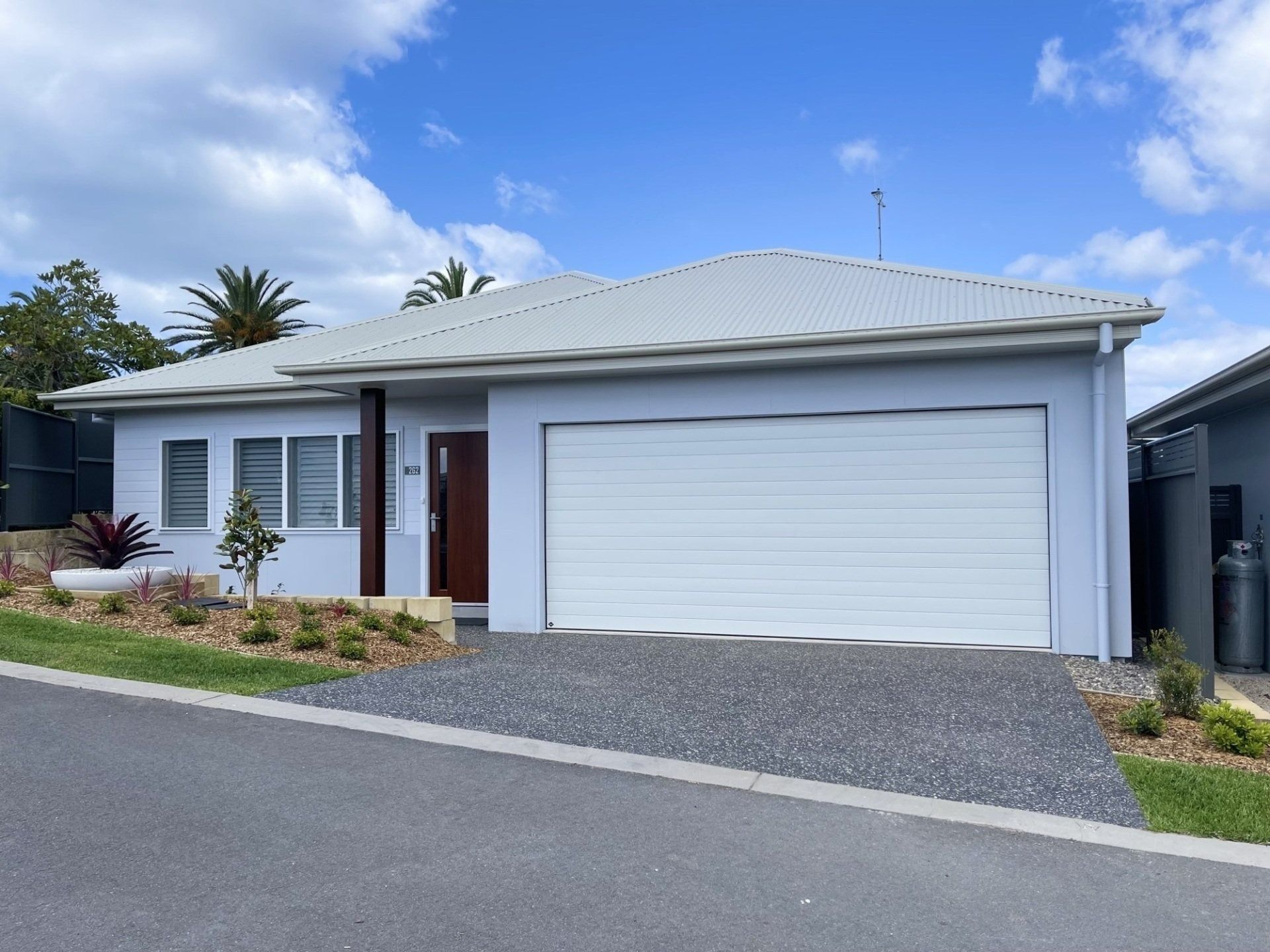 Light Blue House With White Garage Door — G.N Painting and Decorating in Port Macquarie, NSW
