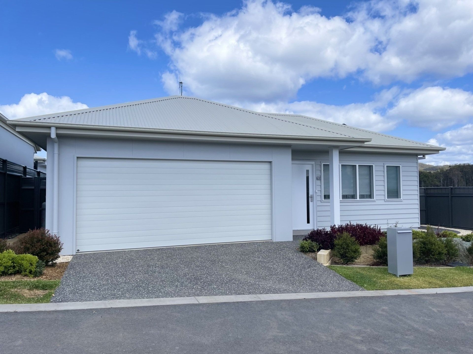Light Blue House With a Garage — G.N Painting and Decorating in Port Macquarie, NSW