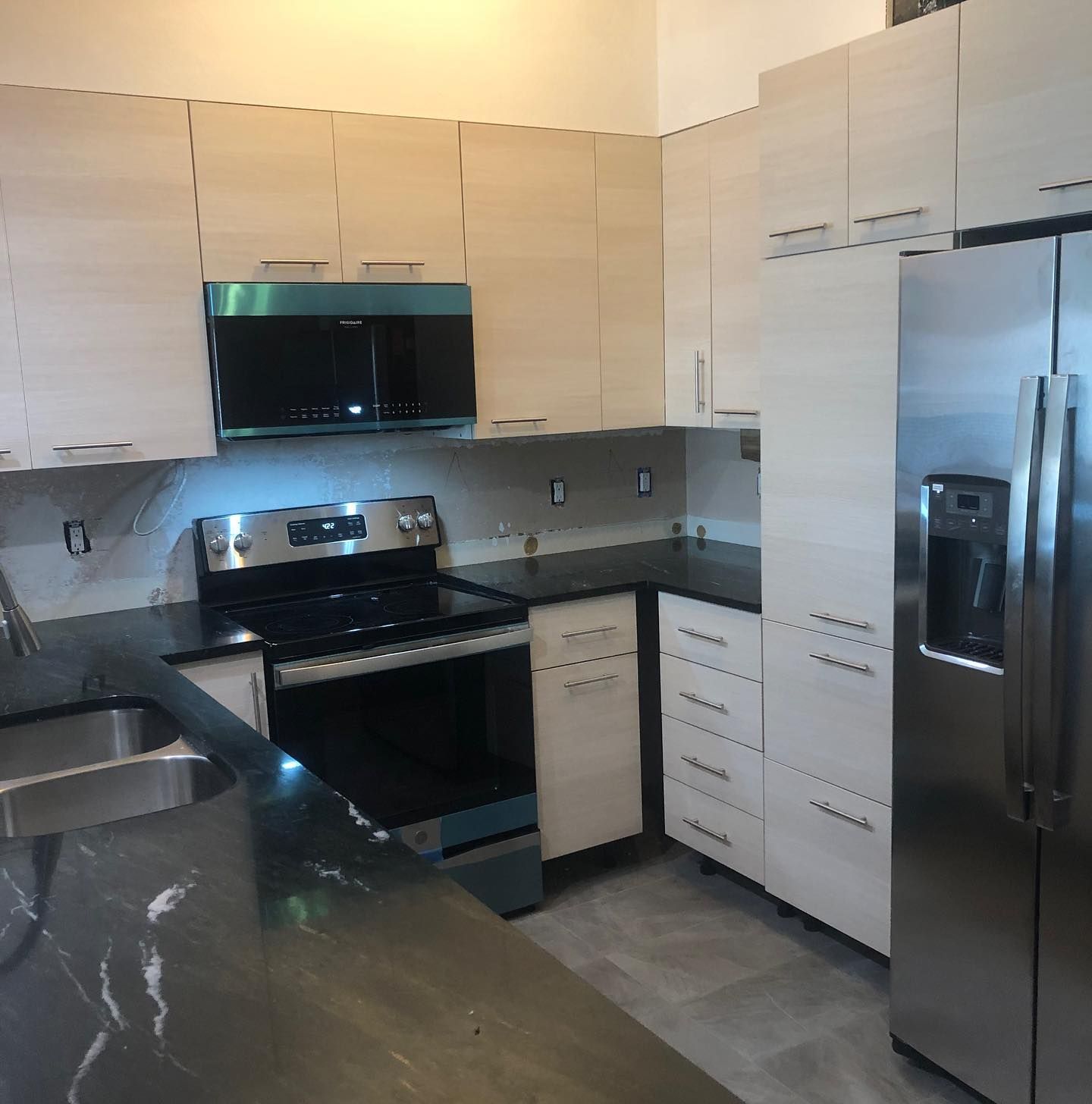 A kitchen with stainless steel appliances and white cabinets