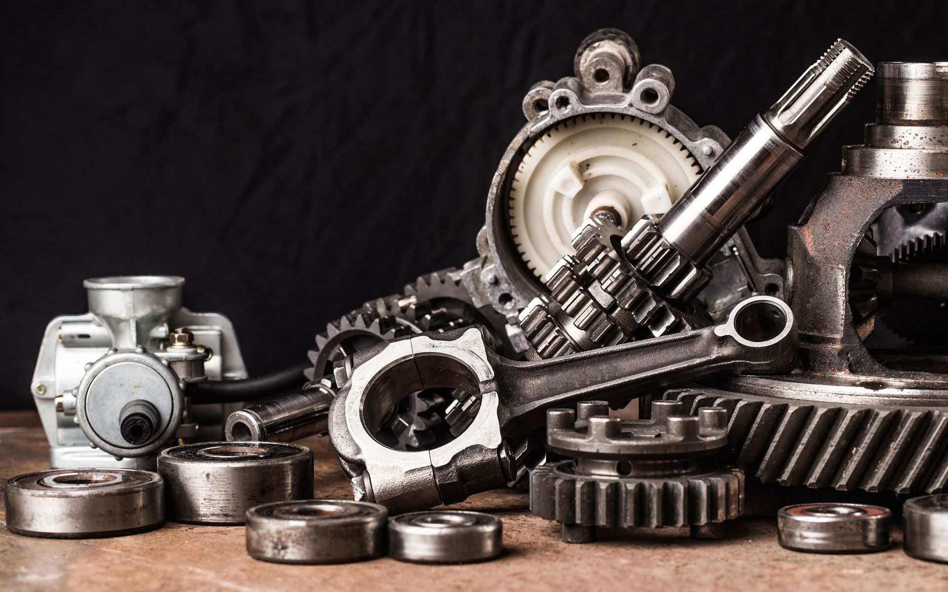 There are many different types of metal parts on the table.