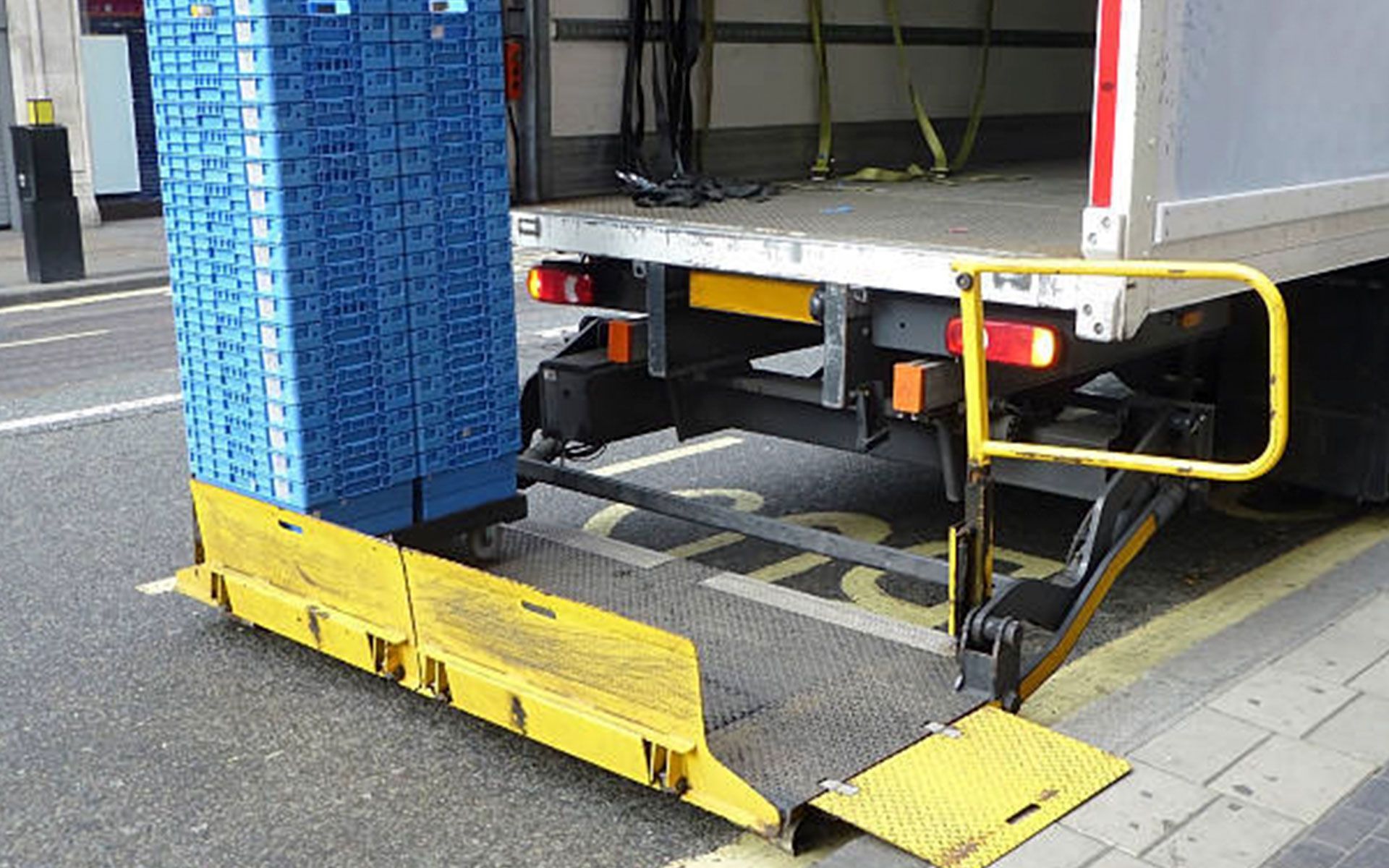 A truck with a ramp attached to the back of it.