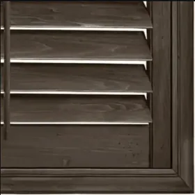 Dark brown wooden window shutters, partially open, with visible slats and frame.