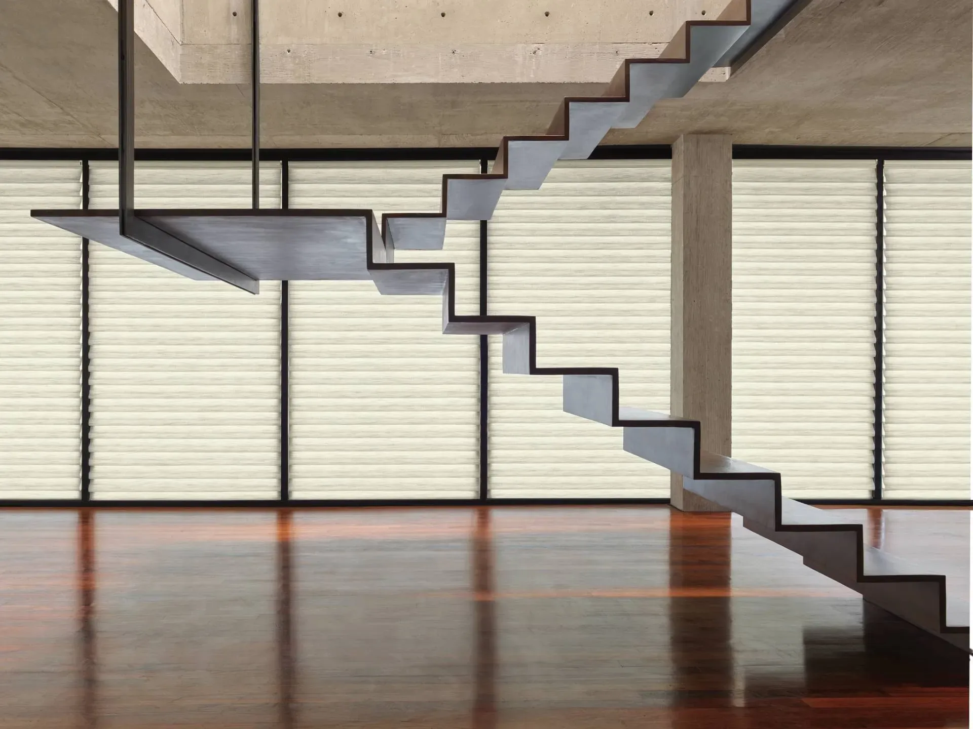 Modern floating staircase with dark wood treads and a metal support structure, interior.