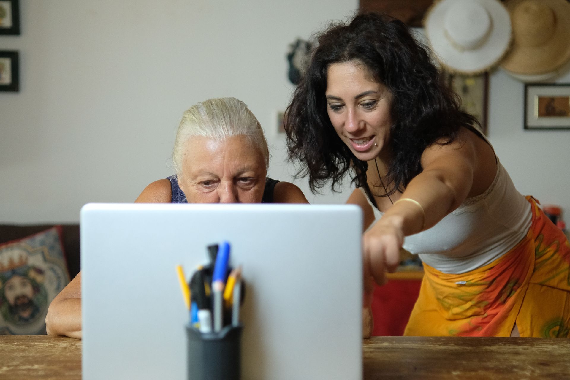 A person is typing on a laptop computer while sitting at a table.