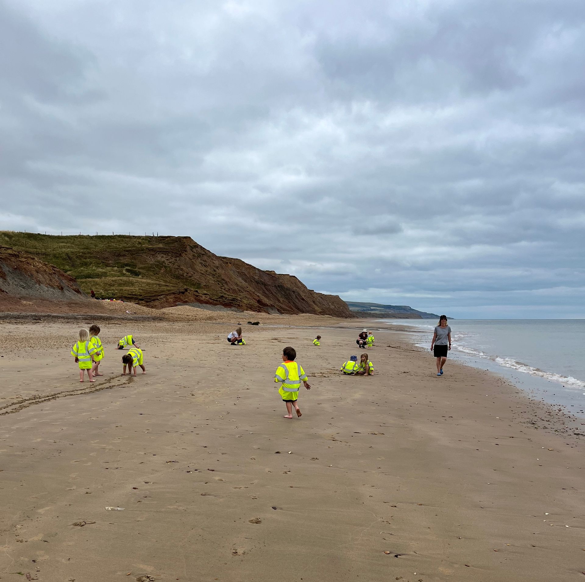 A group of children are playing on a sandy beach
