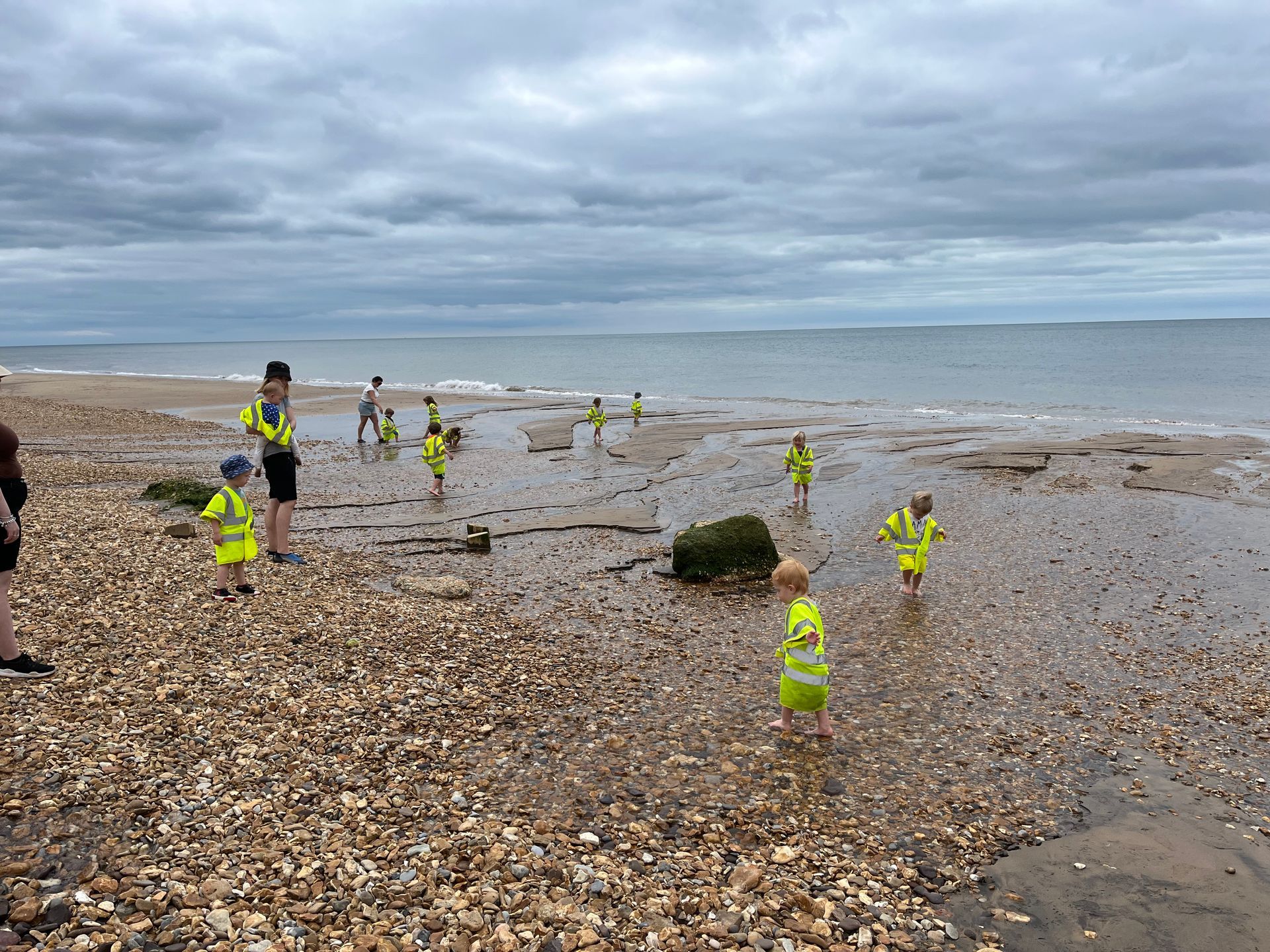 A group of children are playing on a beach.