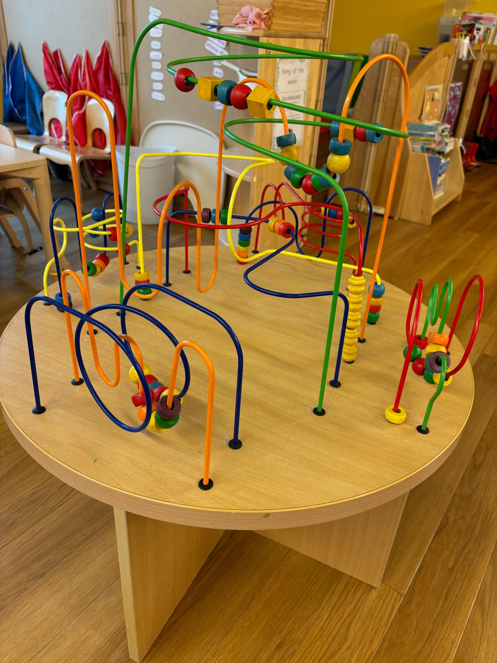 A wooden table with a colorful toy on it.