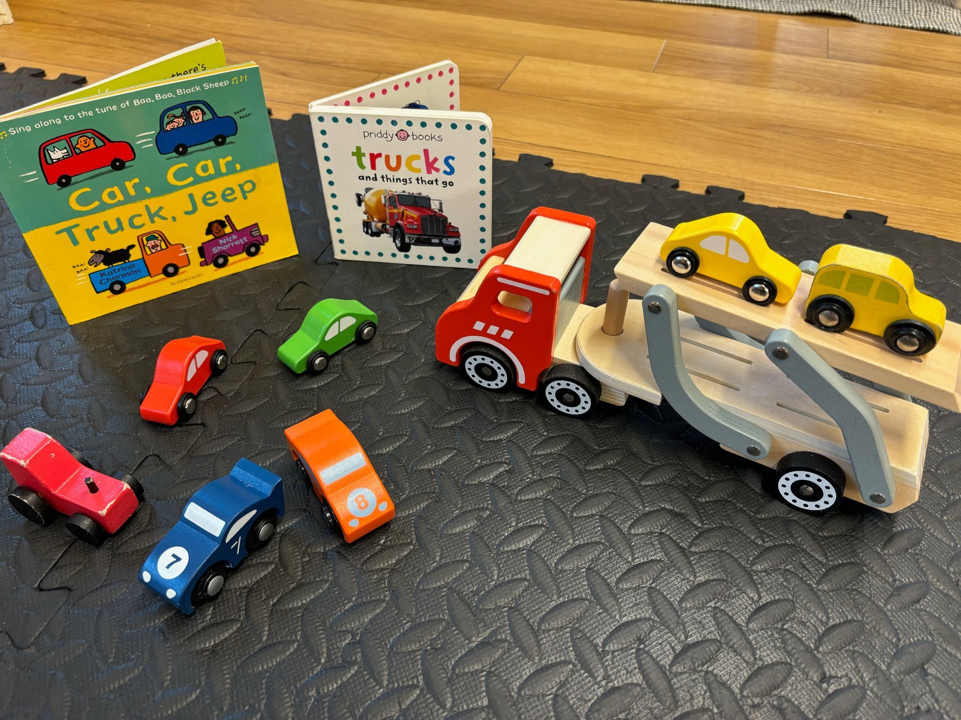 A book about trucks is next to a toy truck