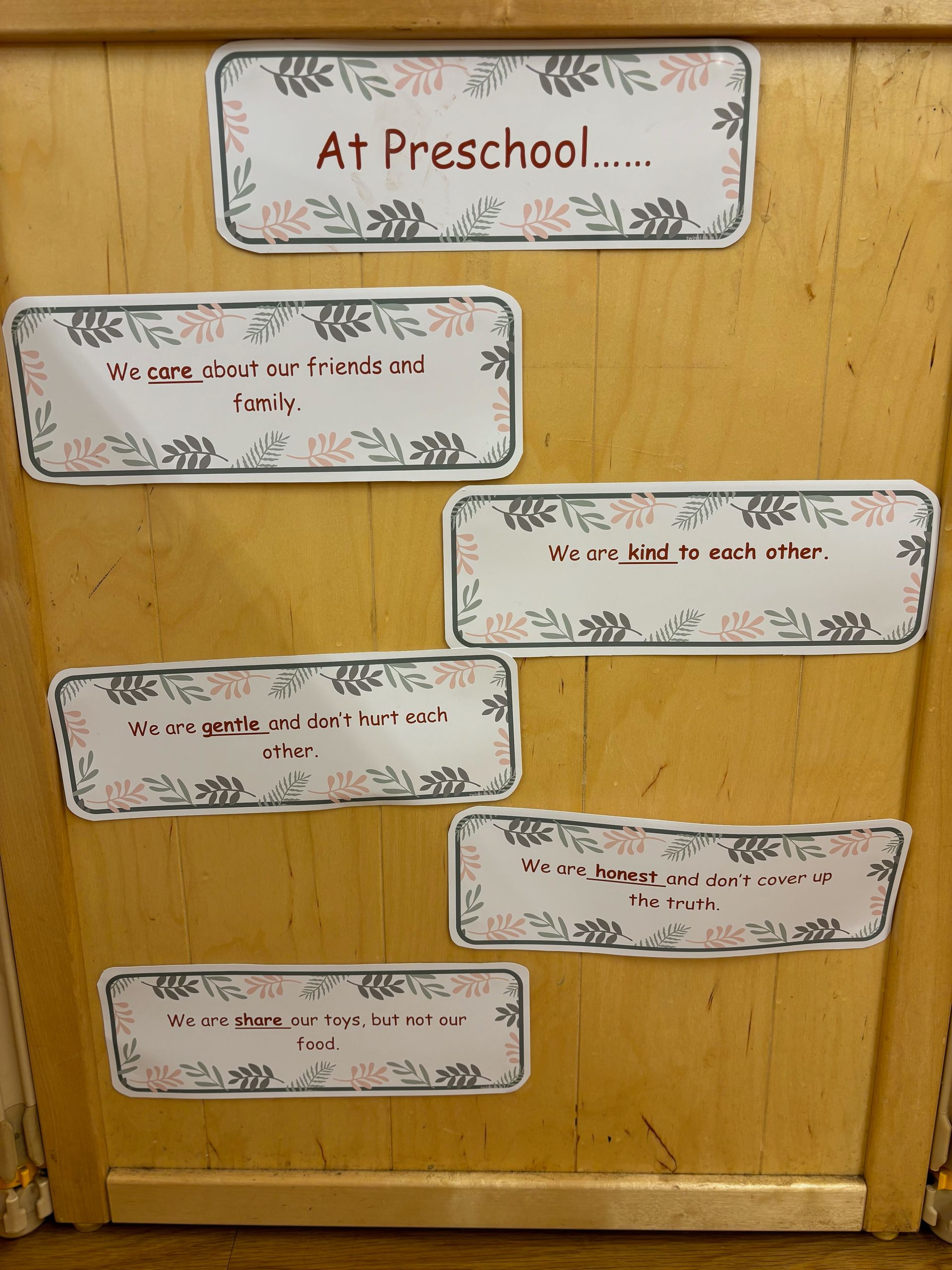 A wooden door with a sign that says at preschool