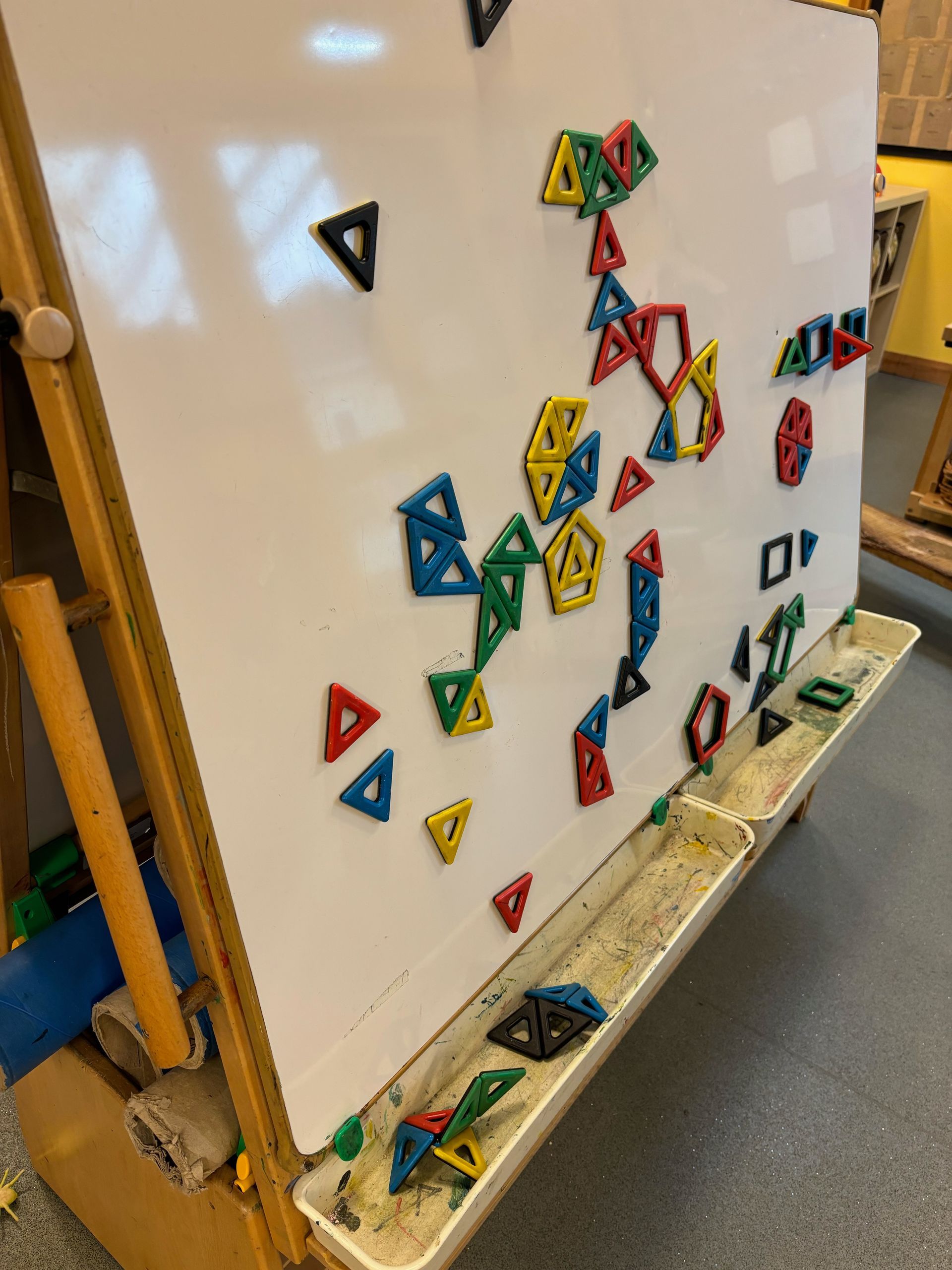 A white board with a bunch of magnets on it