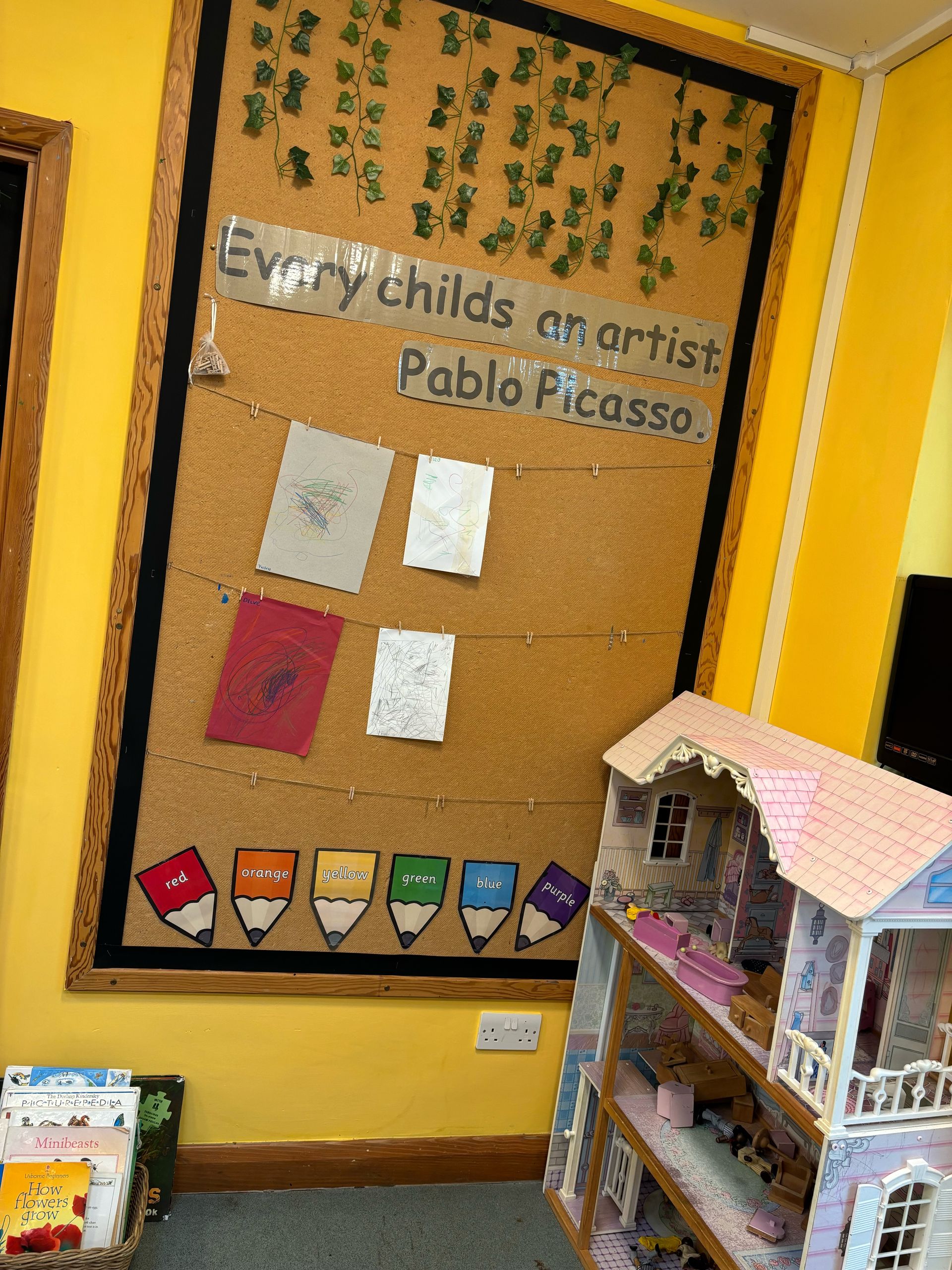 A bulletin board with a quote from pablo picasso