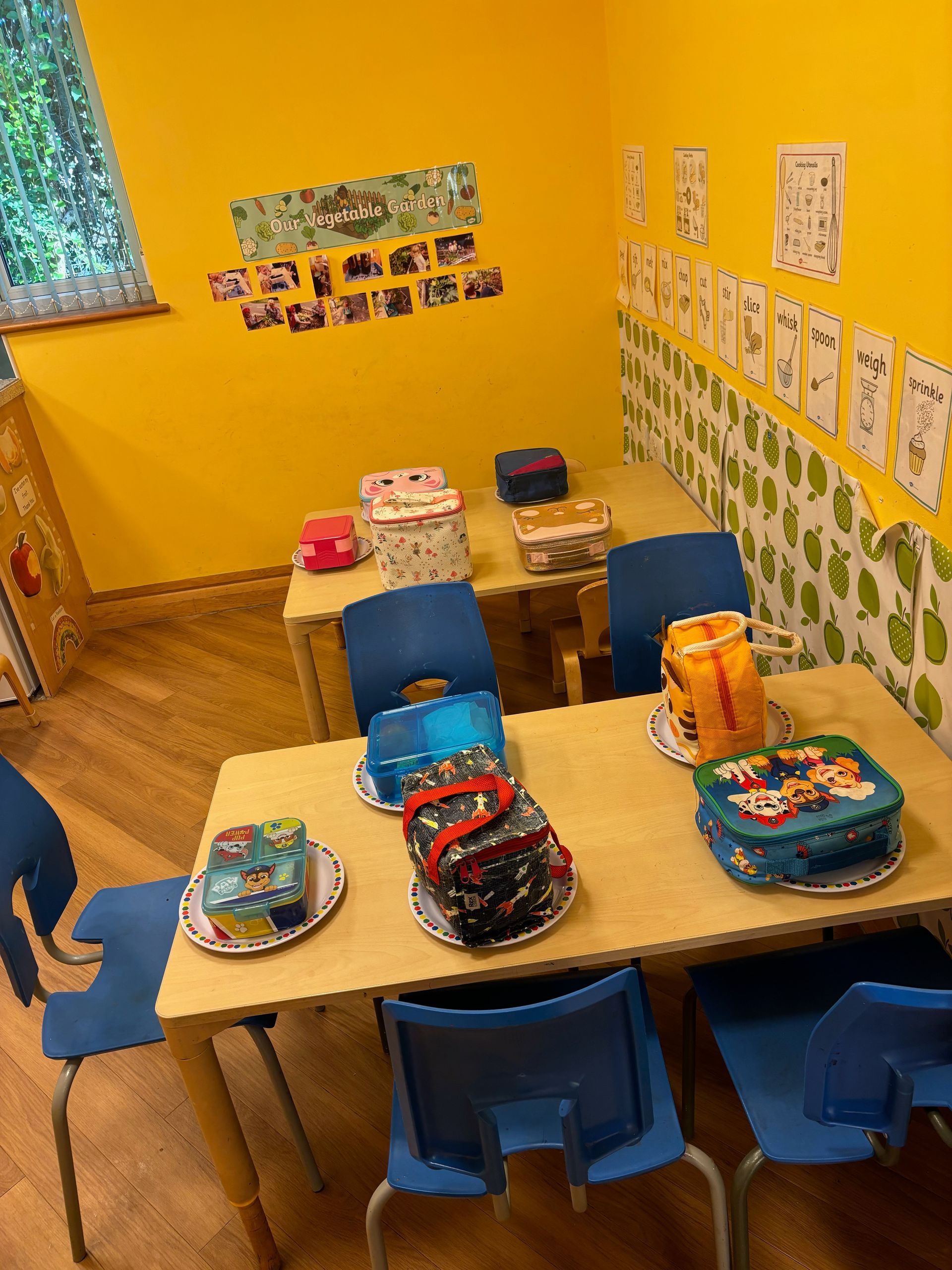 A room with a table and chairs and a yellow wall