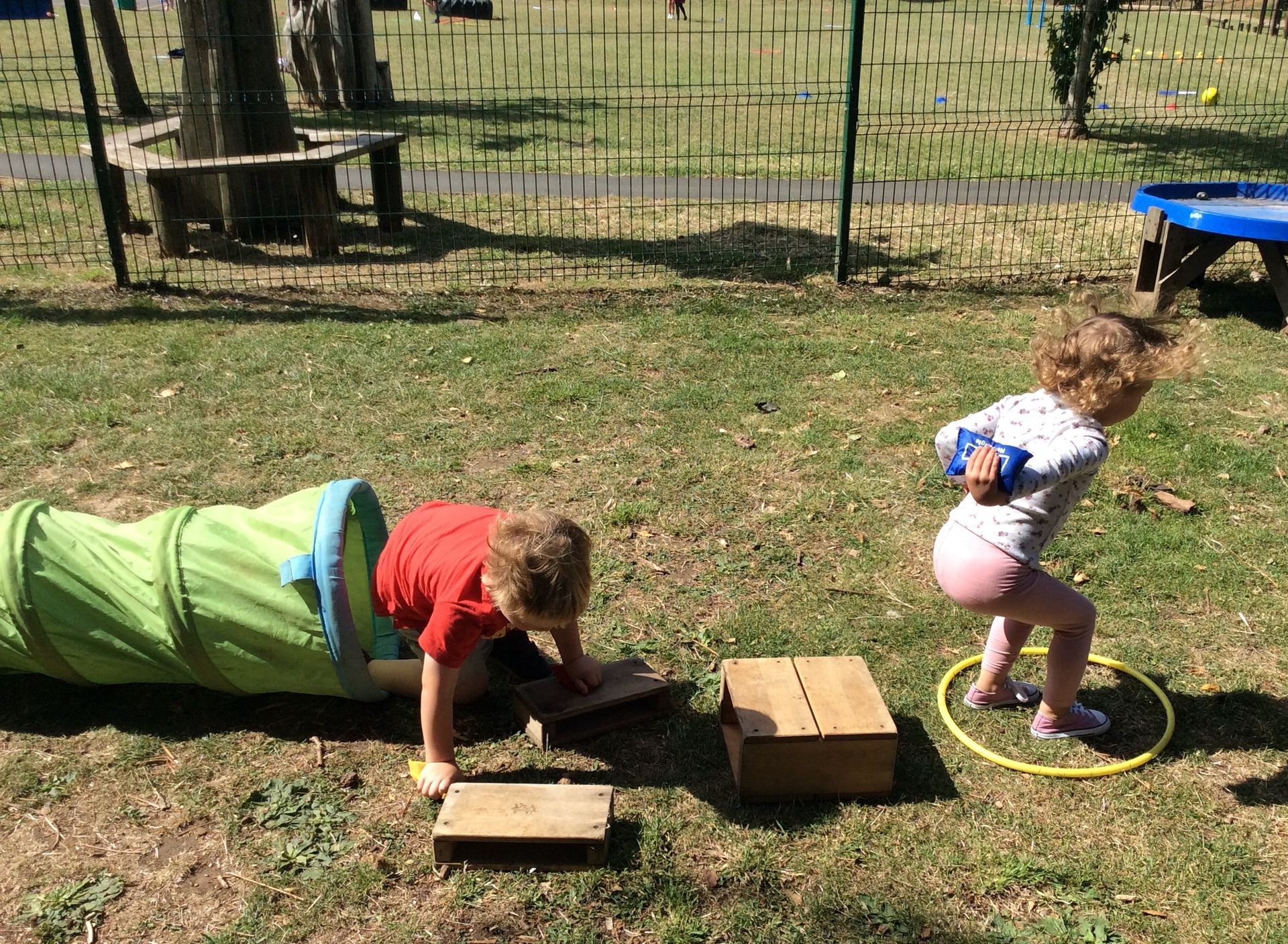 A boy and a girl are playing in a playground.