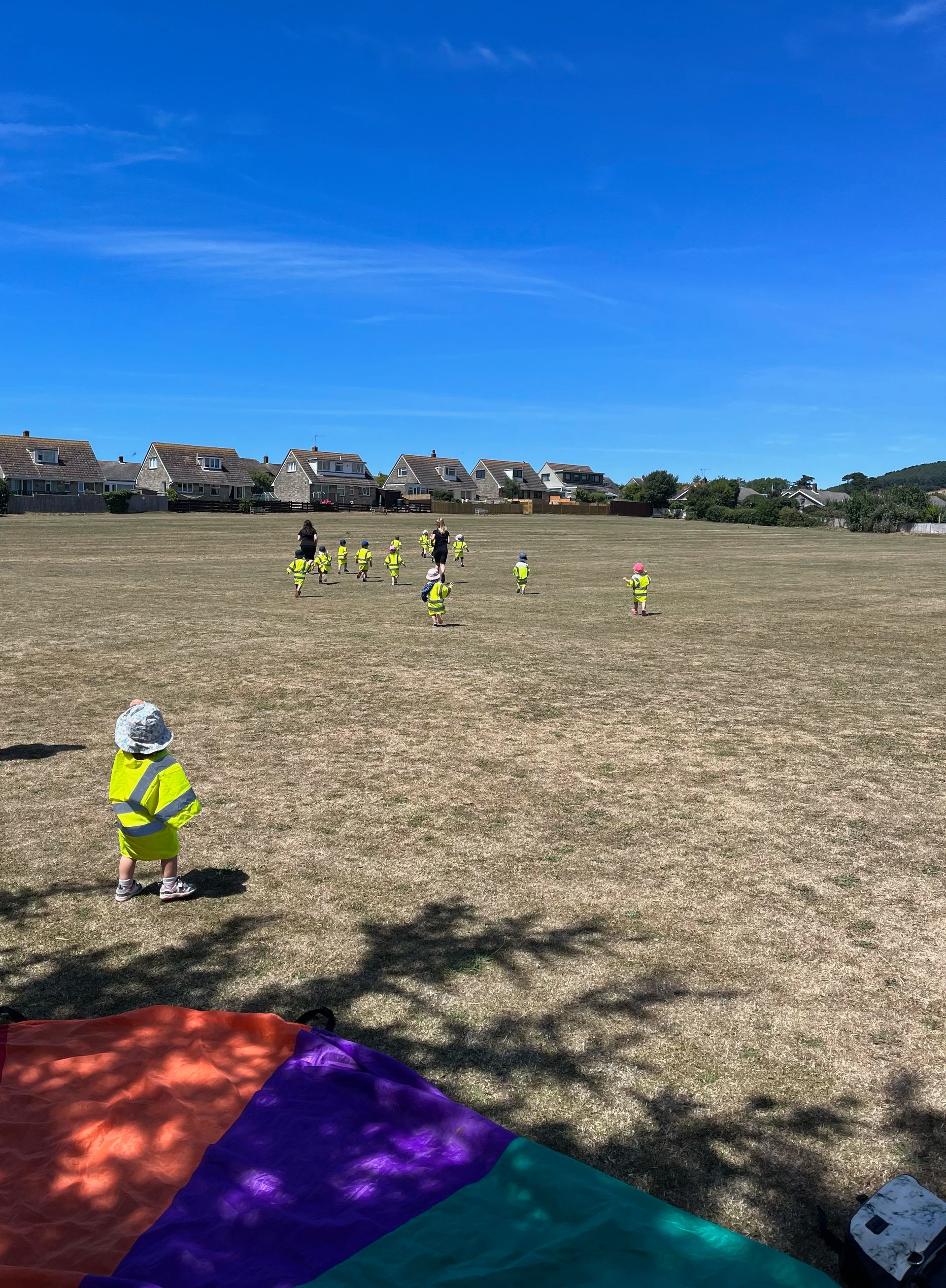 A group of children are playing soccer in a field.