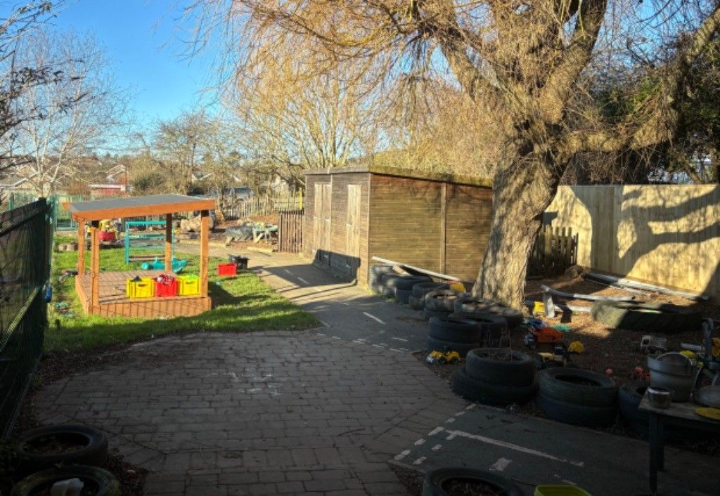 There is a large tree in the middle of the backyard.