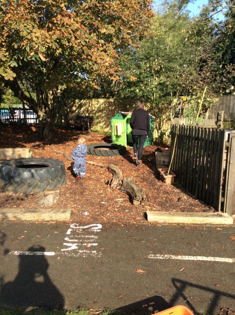 A man and a child are playing in a park.