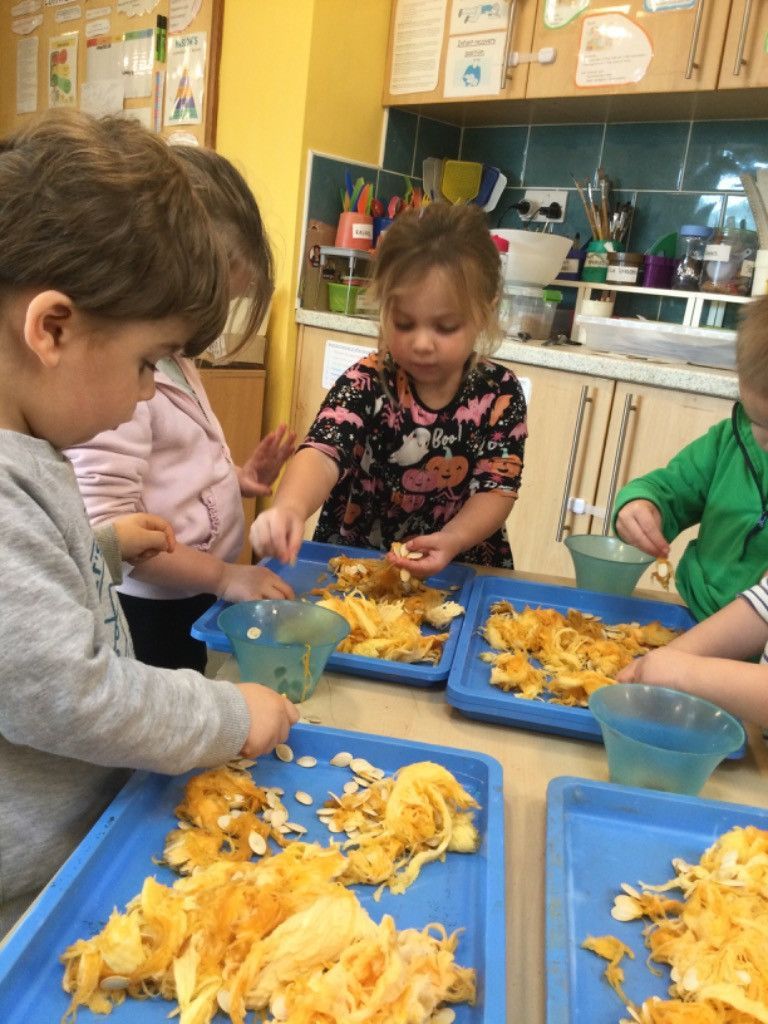 A group of children are playing with food in a kitchen.