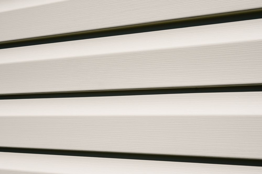 A close up of a white siding with black stripes.