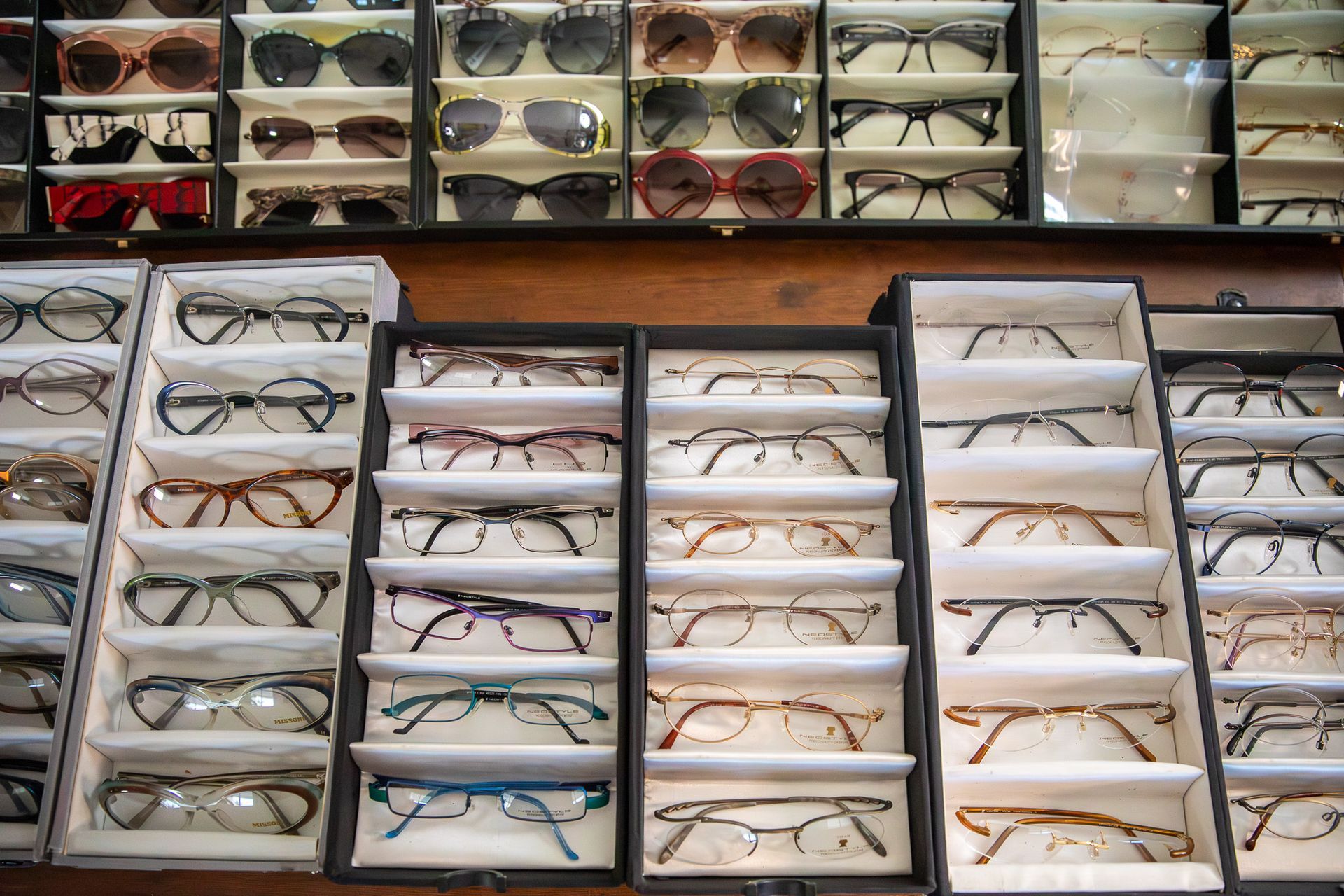 A display of glasses and sunglasses on a table.