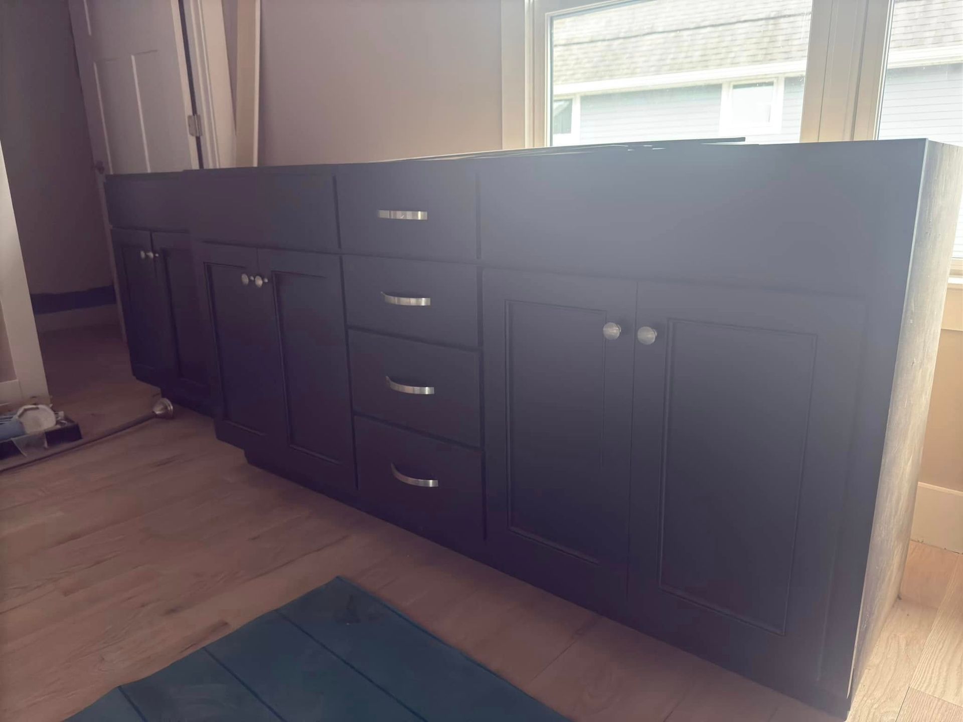 A bathroom vanity with a lot of drawers and cabinets