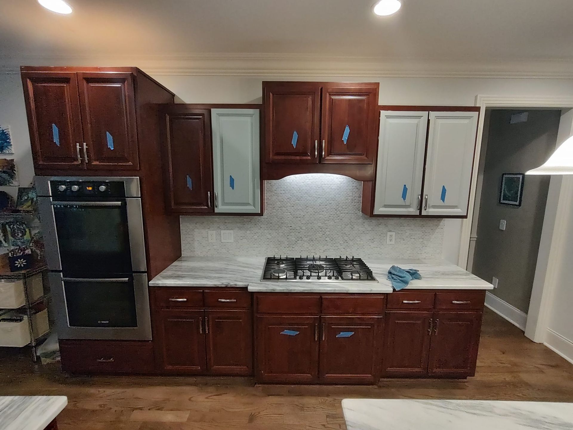 A kitchen with wooden cabinets and a stove top oven.