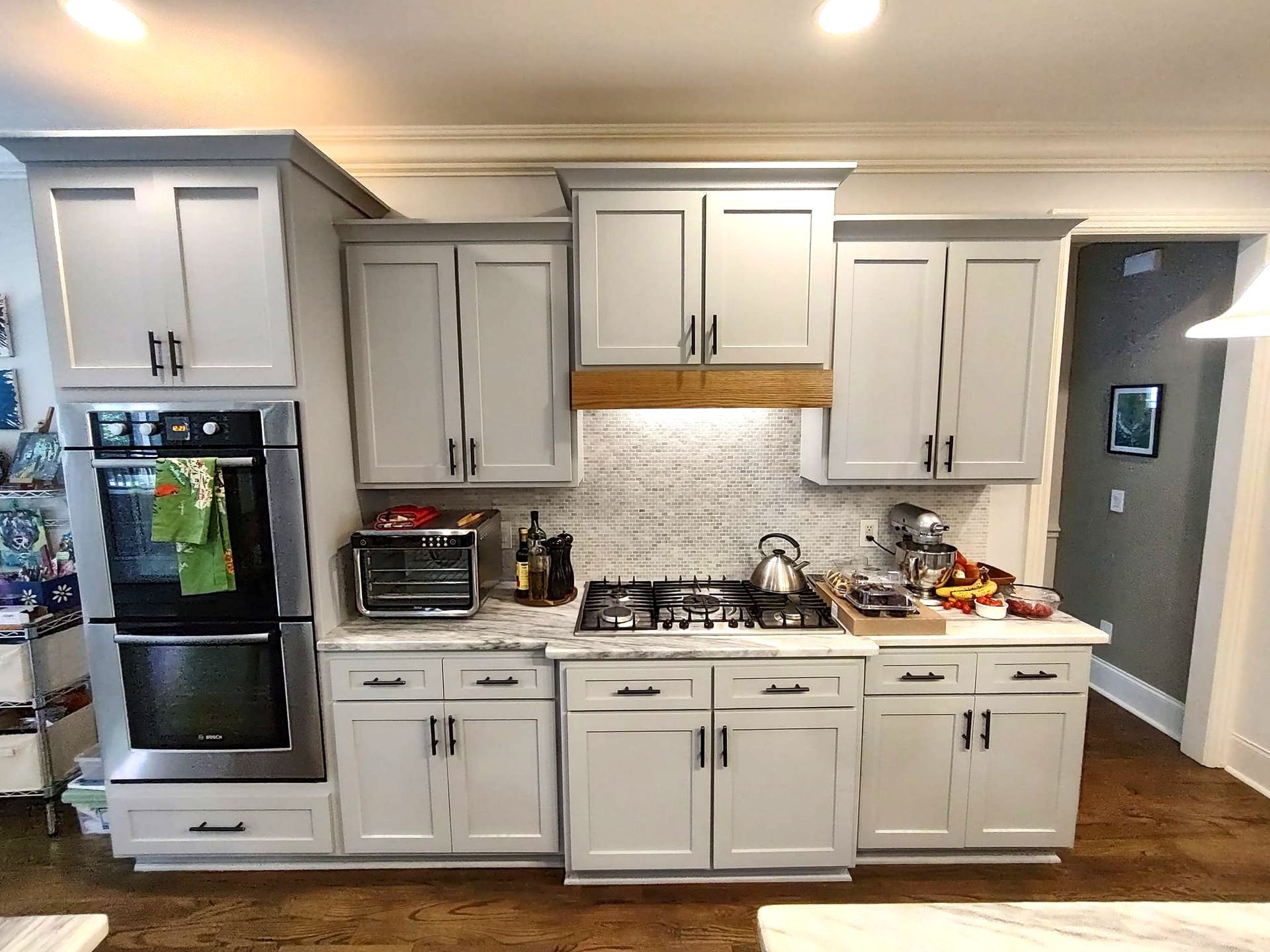 A kitchen with white cabinets and stainless steel appliances.
