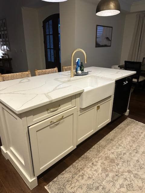 A kitchen with a large island and a sink