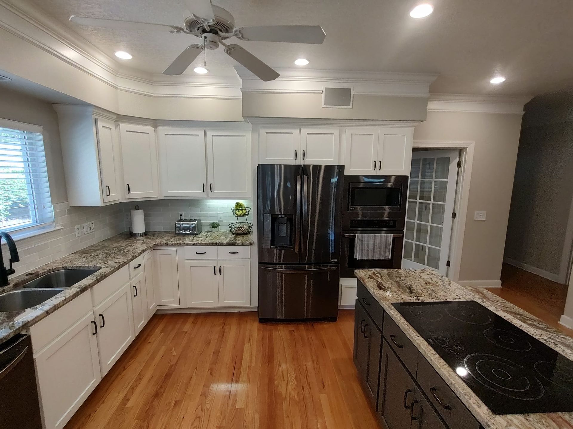 A kitchen with white cabinets and stainless steel appliances