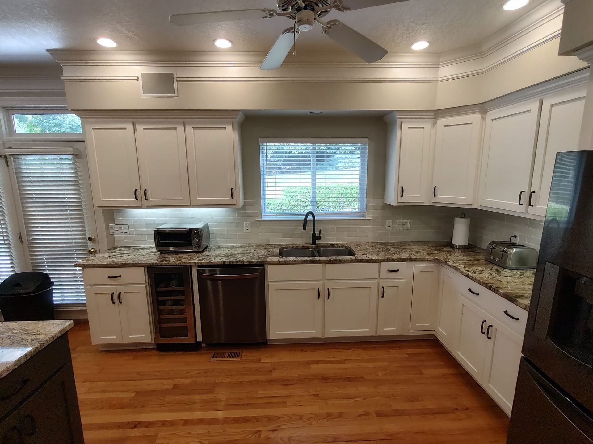 A kitchen with white cabinets and stainless steel appliances