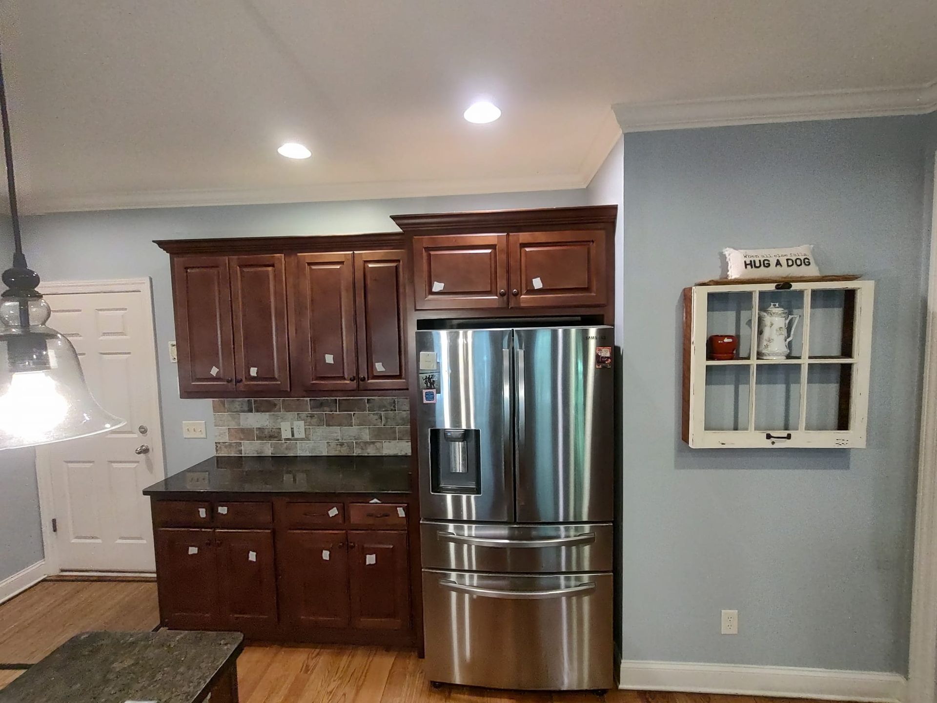 A kitchen with stainless steel appliances and wooden cabinets