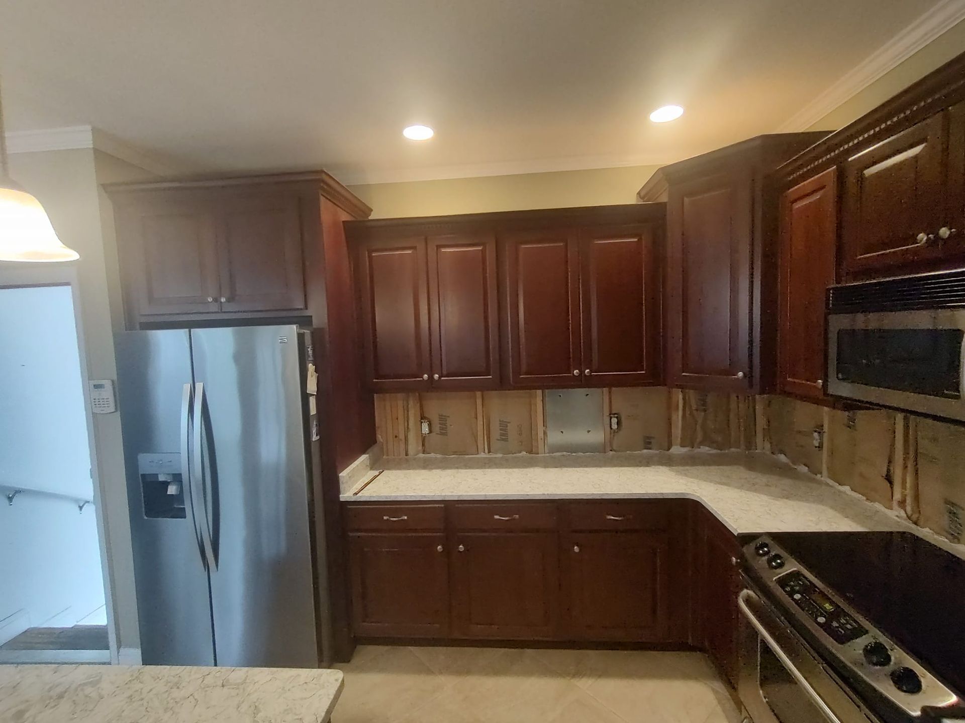 A kitchen with stainless steel appliances and wooden cabinets
