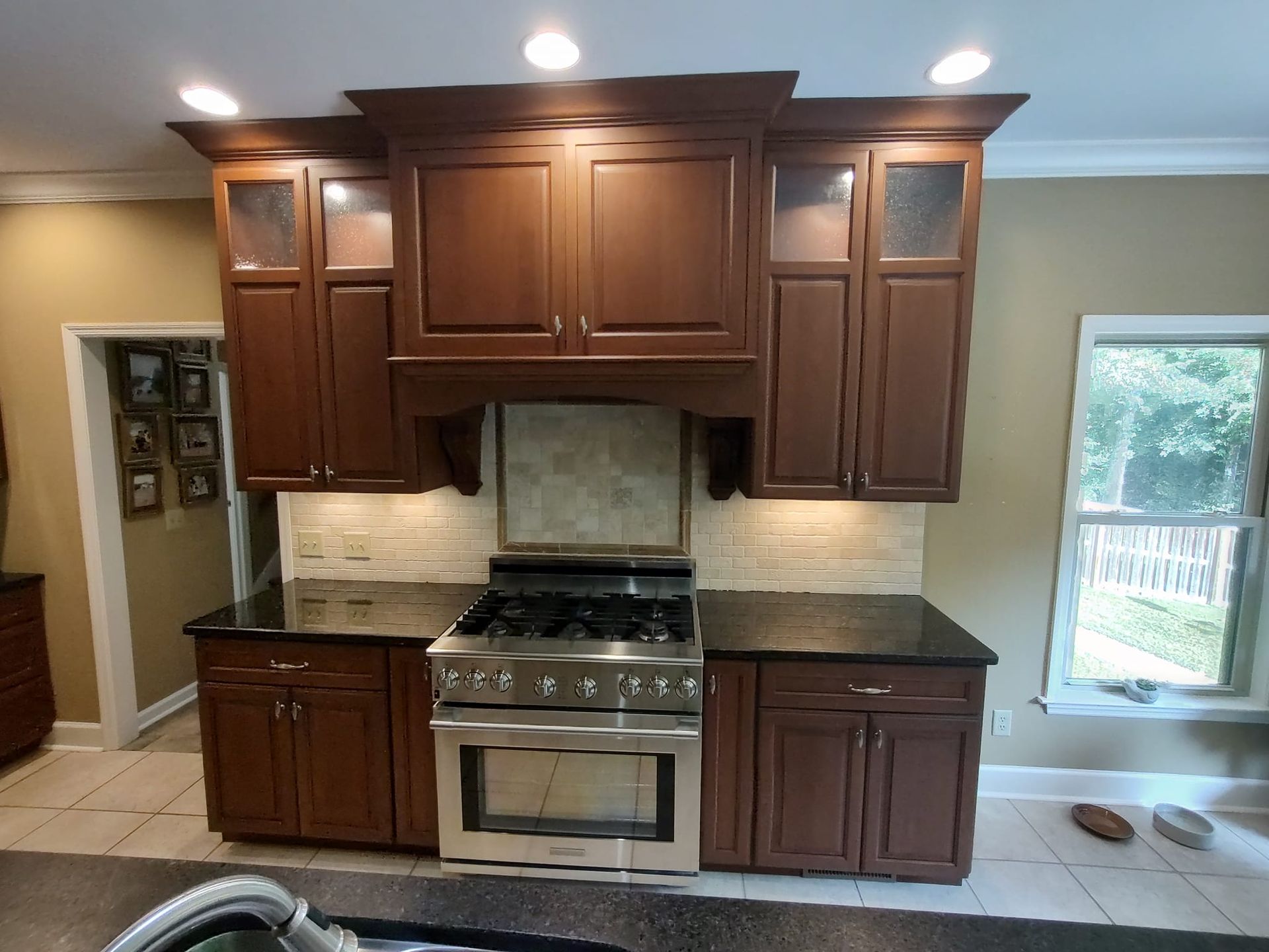 A kitchen with stainless steel appliances and wooden cabinets