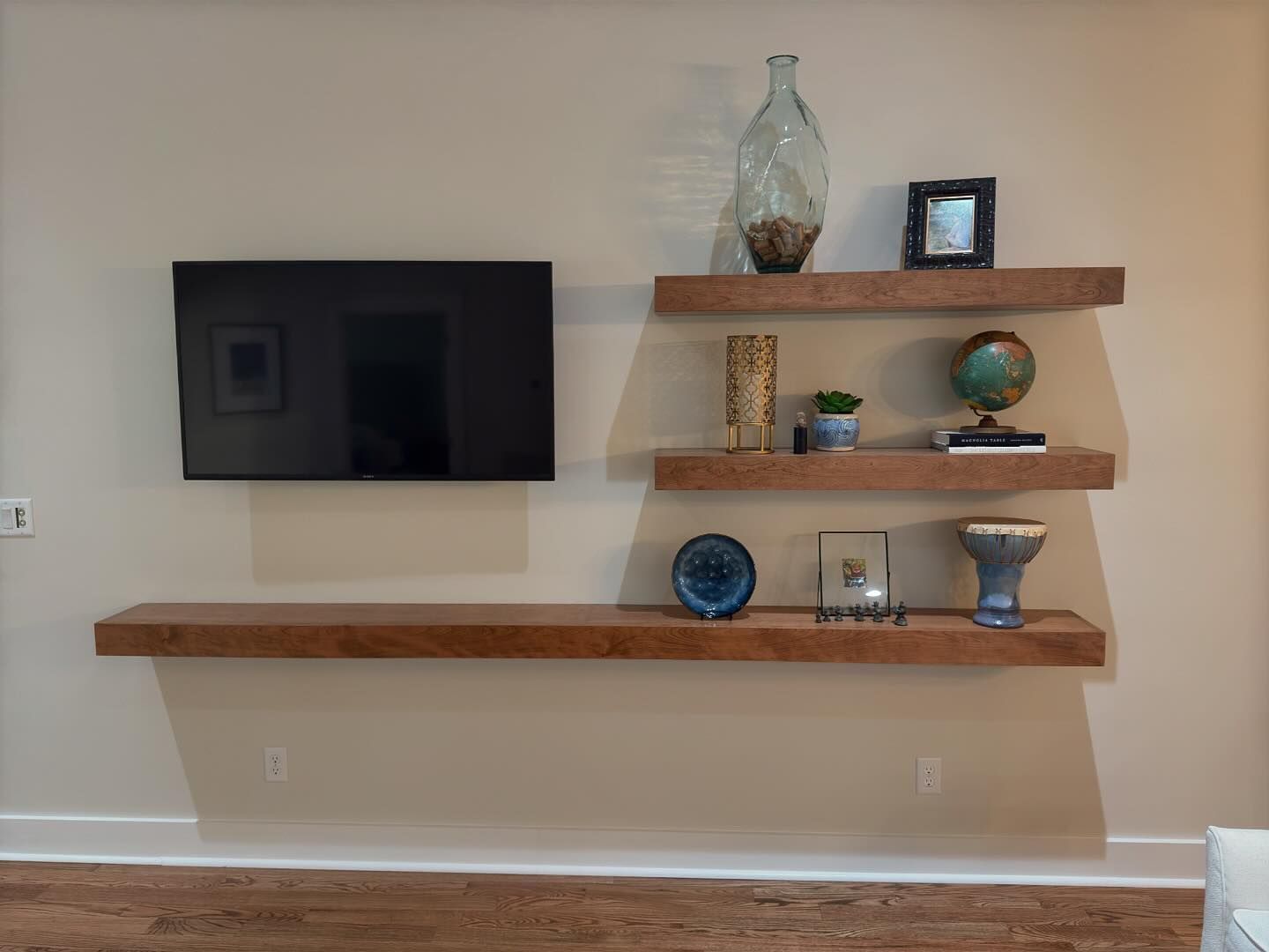 A living room with wooden shelves and a flat screen tv