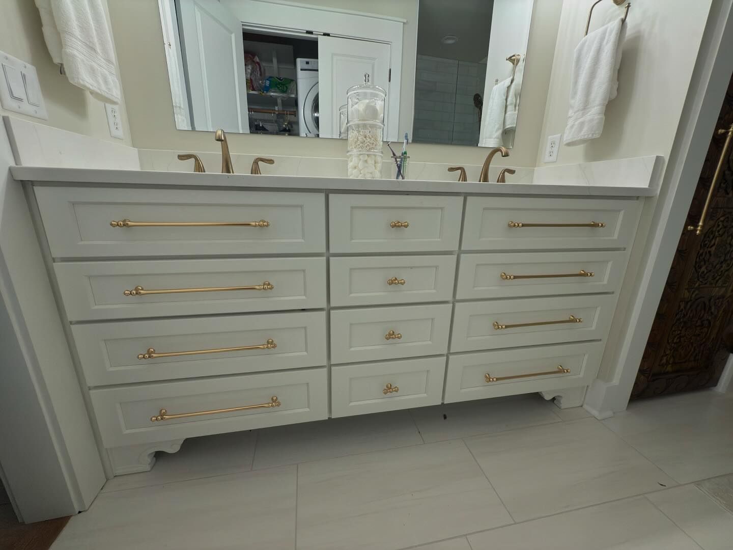 A bathroom with two sinks and a large mirror