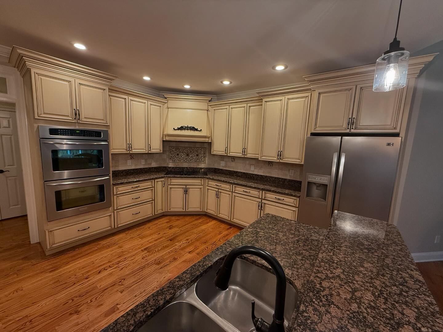 A kitchen with stainless steel appliances and granite counter tops.