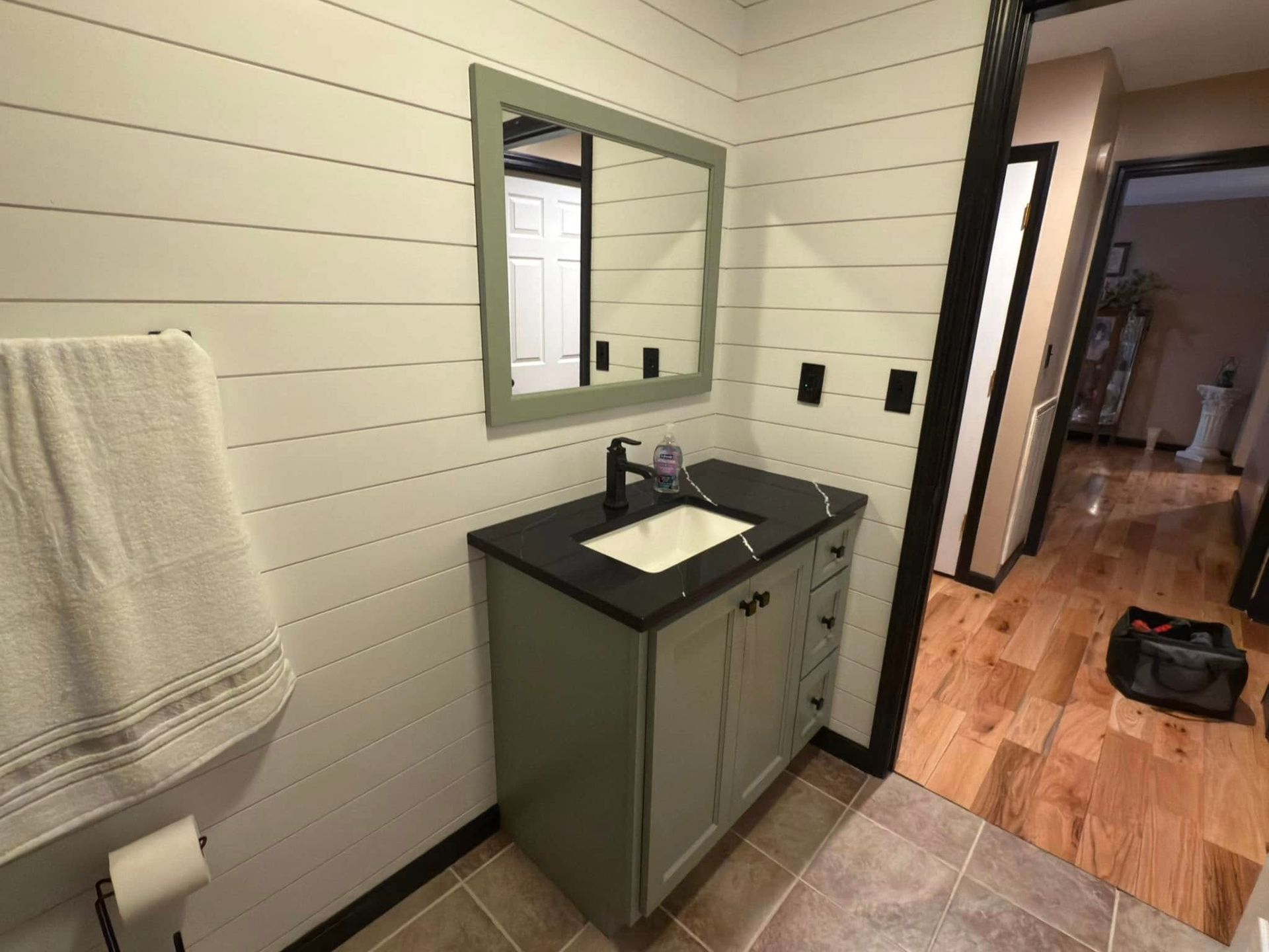 A bathroom with a sink , mirror and pedestal sink.