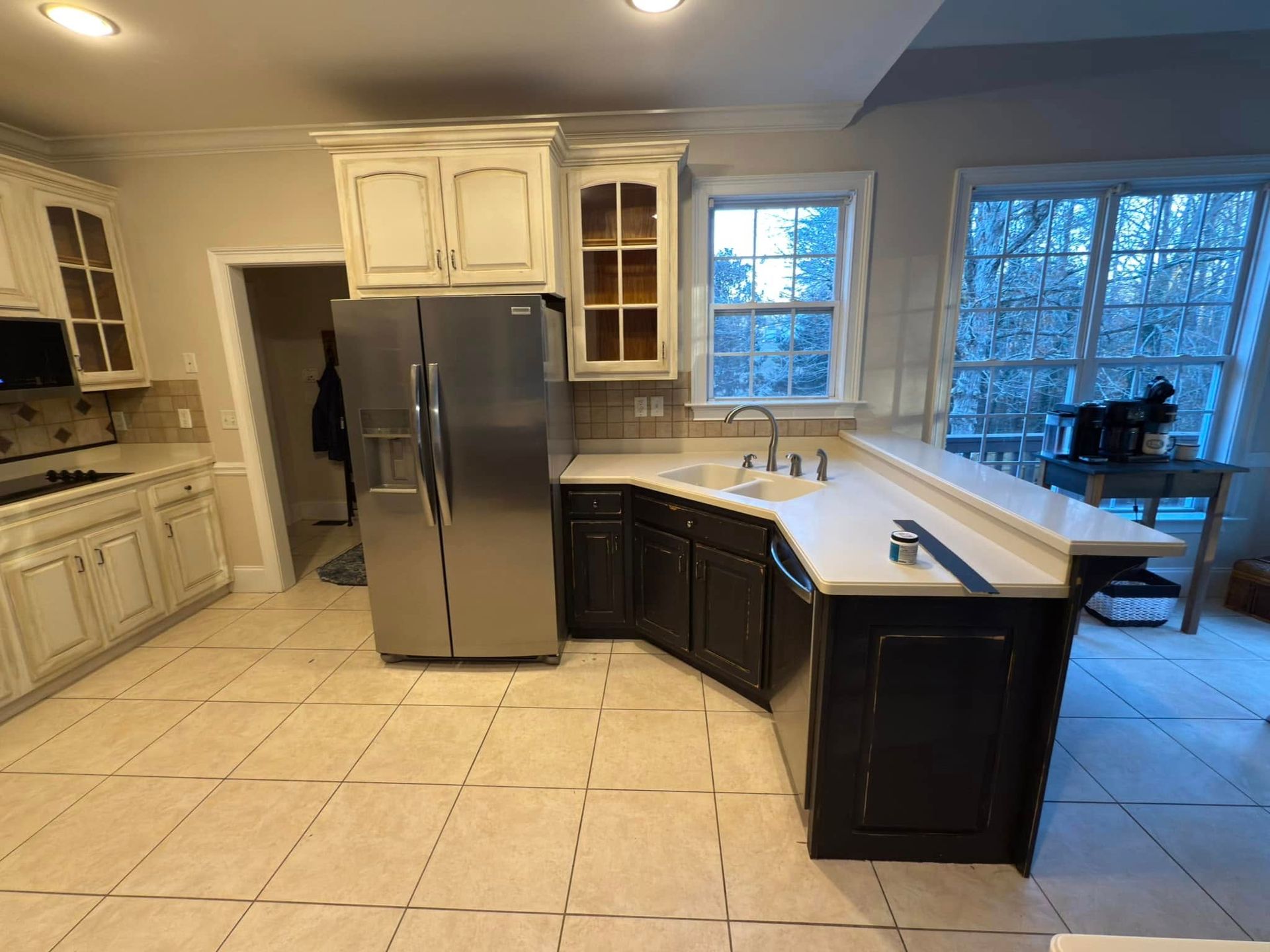 A kitchen with stainless steel appliances and white cabinets