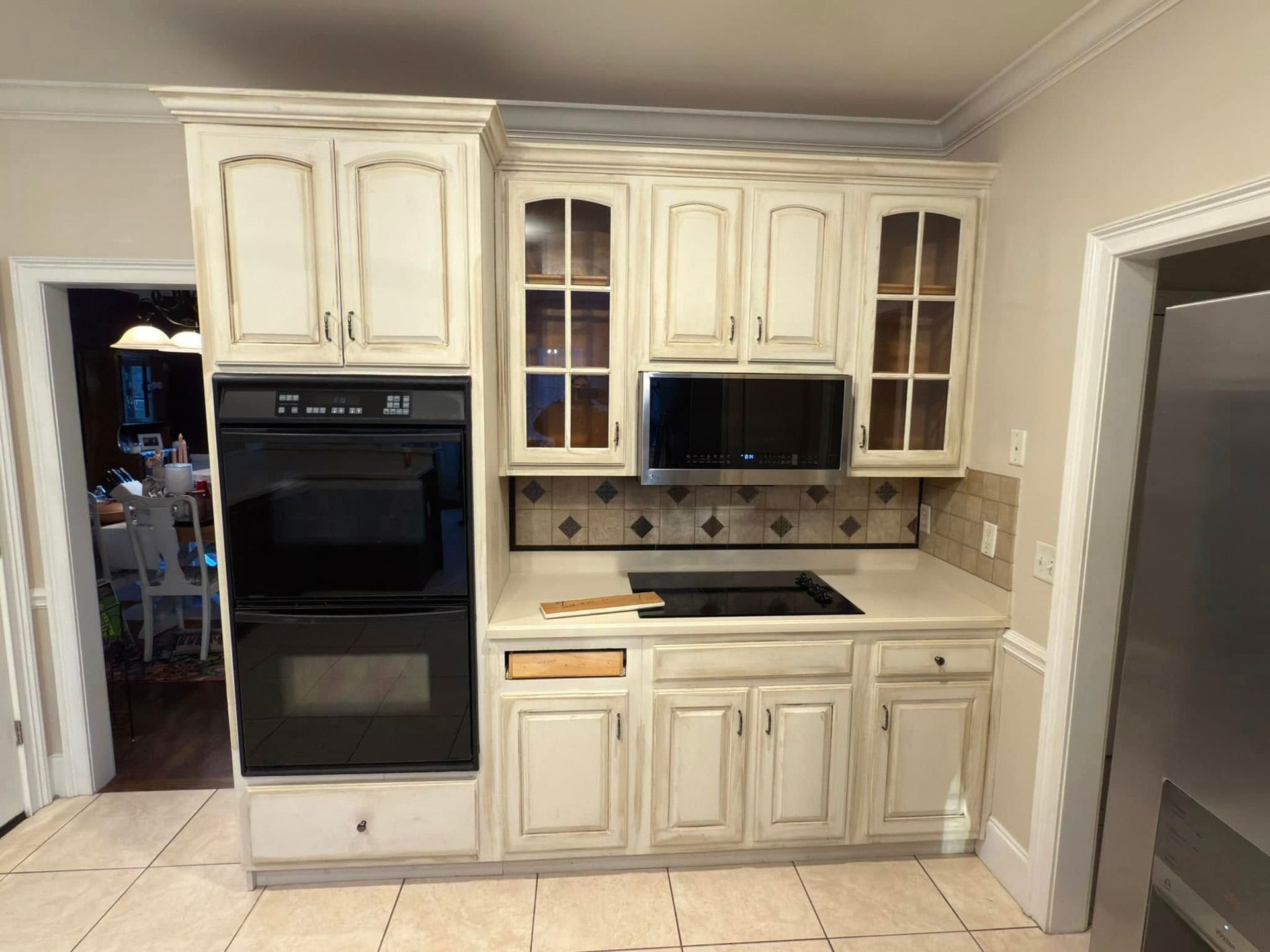 A kitchen with white cabinets and stainless steel appliances