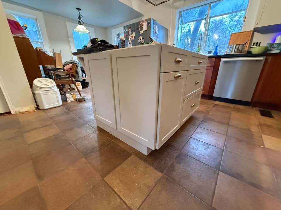 A kitchen with a large island in the middle of it.
