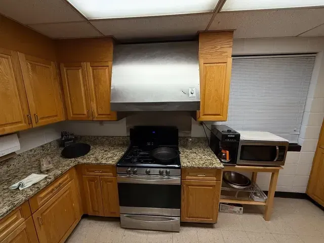 A kitchen with stainless steel appliances and wooden cabinets