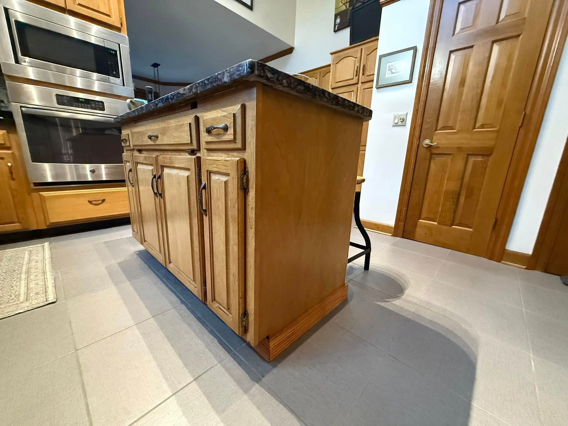 A kitchen with stainless steel appliances and wooden cabinets